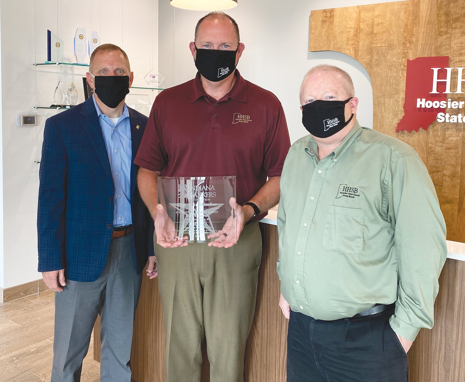 Displaying HHSB’s Five Star Member award from the Indiana Bankers Association are, rom left, IBA Executive Vice President Rod Lasley, President Brad Monts and CEO Trey Etcheson.